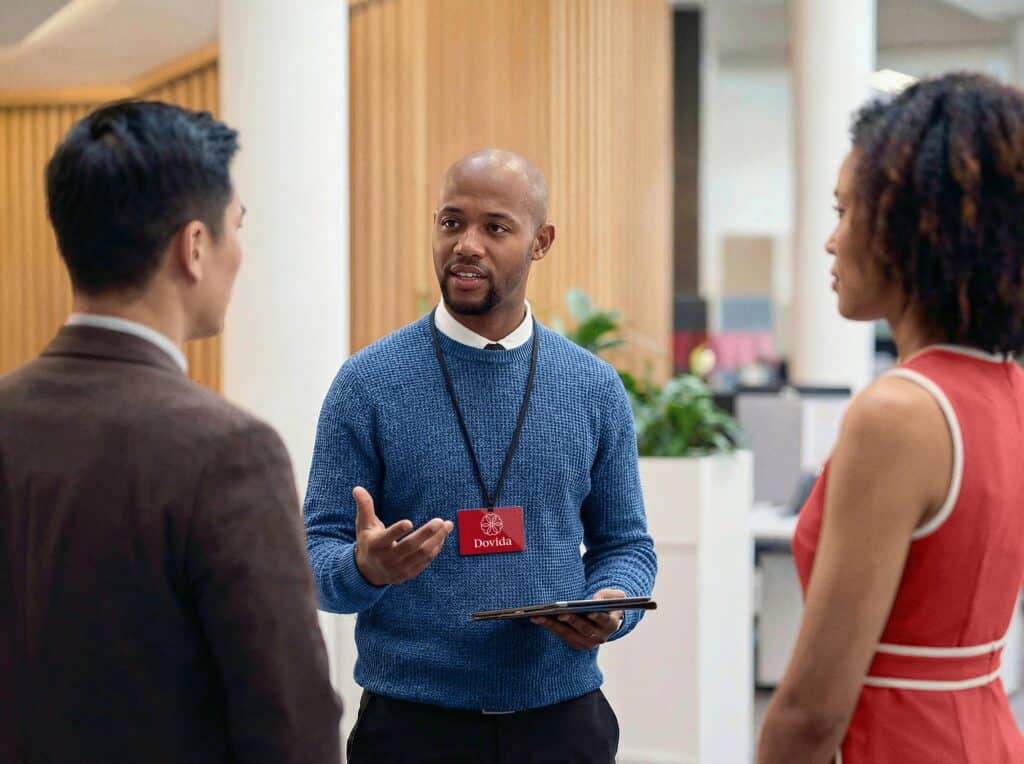 Male Dovida agent having a conversation with peers